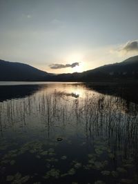 Scenic view of lake against sky during sunset