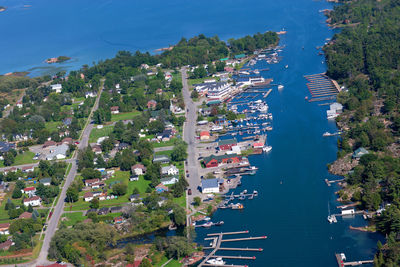 High angle view of trees and buildings by sea
