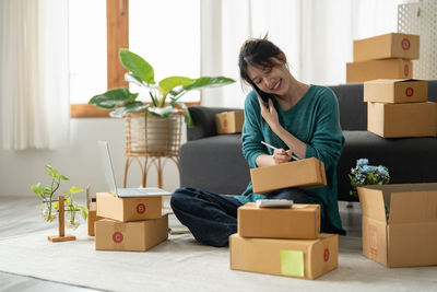 Side view of woman using digital tablet at home