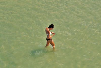 Full length of shirtless man in sea