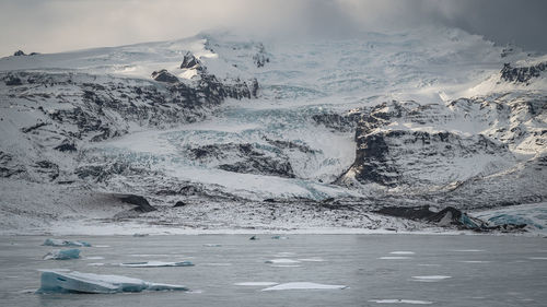 Scenic view of glacier with lake 