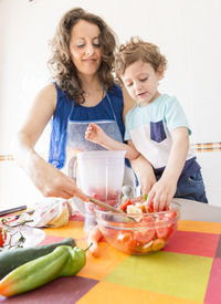 Portrait of woman holding food at home