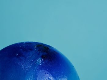 Close-up of bubbles over blue background