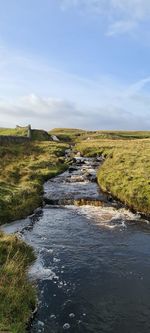 Scenic view of waterfall against sky