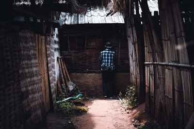 Rear view of man standing in abandoned building