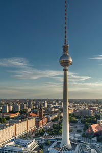 Fernsehturm against buildings in city