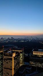 High angle view of illuminated buildings against sky at dusk in tokyo