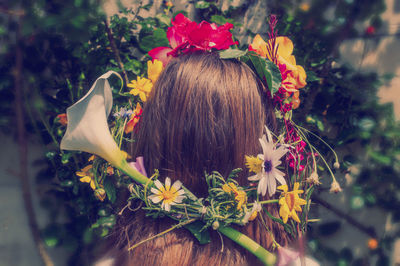 Rear view of woman with flowers