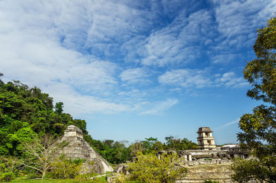 Historic temples by trees against sky