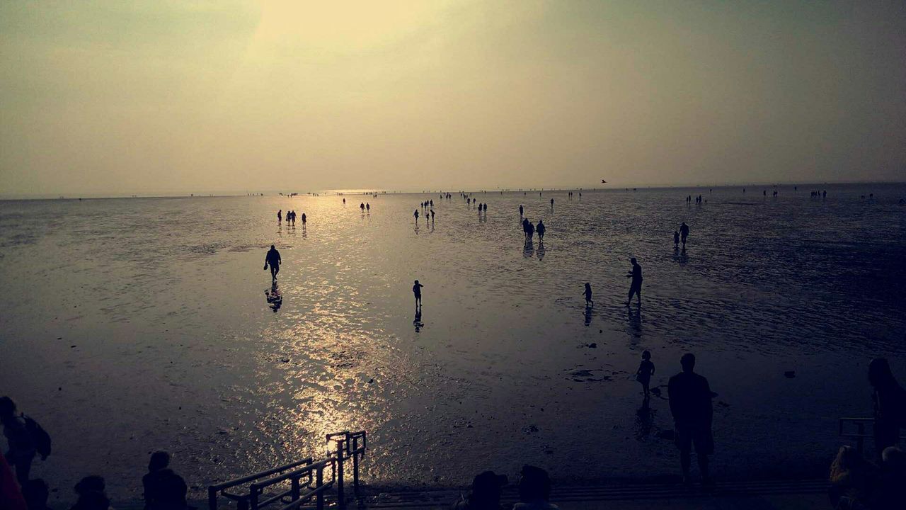 water, sea, horizon over water, sunset, silhouette, beach, leisure activity, lifestyles, sky, large group of people, men, scenics, shore, reflection, beauty in nature, nature, person, vacations, tranquil scene