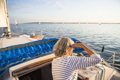 Rear view of woman looking at sea against sky