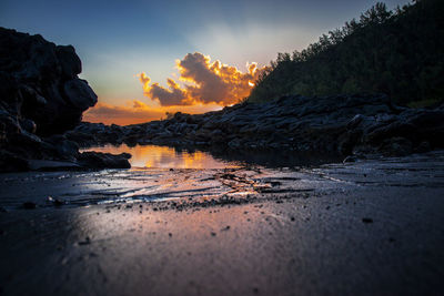 Scenic view of beach against sky during sunset