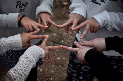 Cropped image of friends making star shape