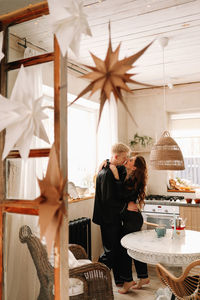 A couple in love have breakfast and drink tea in a decorated eco-style kitchen in a country house