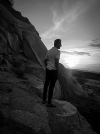 Rear view of man standing on rock
