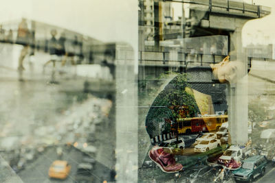 Double exposure of woman on city street