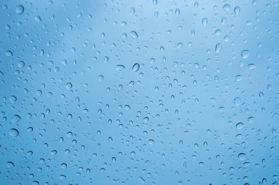 Full frame shot of wet glass window during rainy season