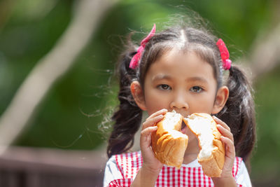 Portrait of cute girl eating food