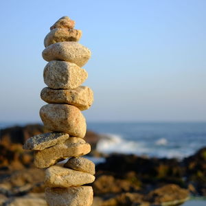 Stack of pebbles against beach