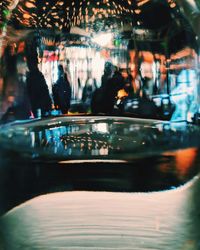 Reflection of illuminated glass on table