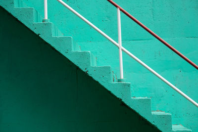 Full frame shot of staircase with green wall in the background.