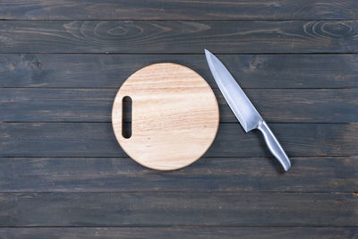 High angle view of arrow symbol on wooden table