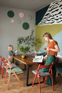 Woman sitting on table at home