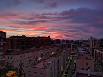 High angle view of illuminated buildings against sky at sunset