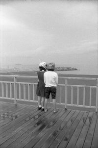Rear view of woman looking at sea against sky