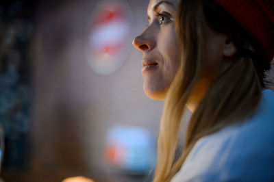 Close-up portrait of young woman looking away