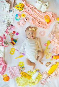 High angle view of cute baby boy lying on bed