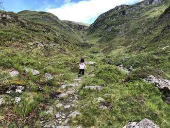 Rear view of woman walking on trail