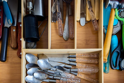 High angle view kitchen equipment arranged in drawer