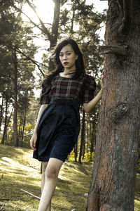 Portrait of beautiful young woman in forest