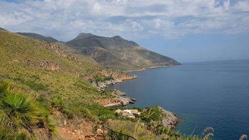 Scenic view of sea and mountains against sky