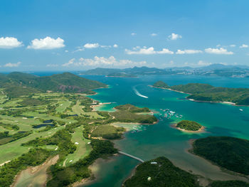 Scenic view of sea and mountains against sky