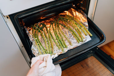 Green asparagus sprouts on frying pen in kitchen. grilled fresh vegetables