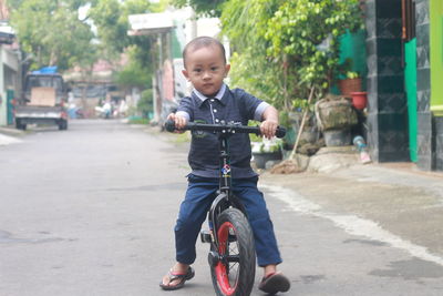 Portrait of toddler boy riding a pushbike