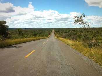 Empty road along countryside landscape