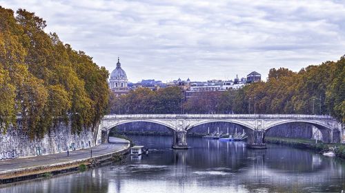 Bridge over river against sky during autumn