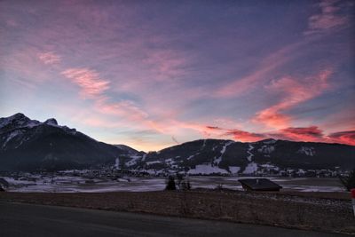 Scenic view of snowcapped mountains against sky at sunset