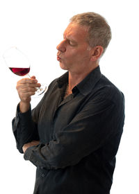 Full length of a man drinking glass against white background