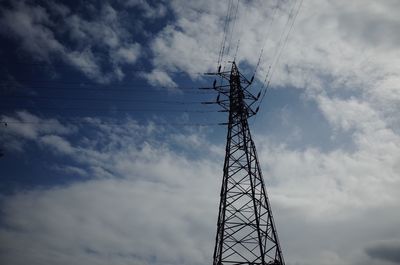 Low angle view of electricity pylon against sky