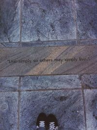 Low section of person standing on tiled floor