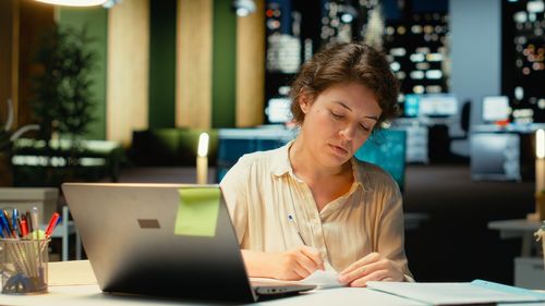 Young woman using laptop at table