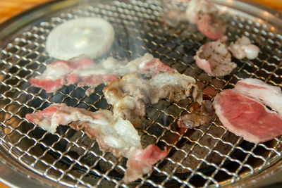 High angle view of meat on barbecue grill