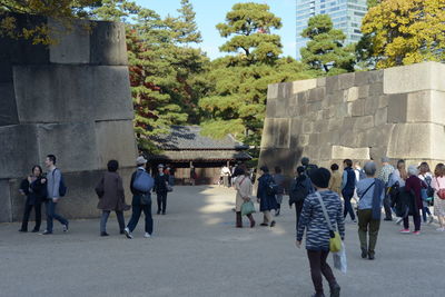 Group of people walking in front of building