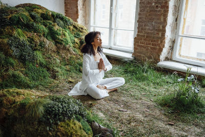 Young woman sitting on rock