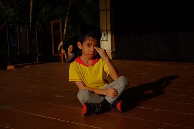 Portrait of boy sitting outdoors