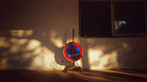 Road sign on wall at night